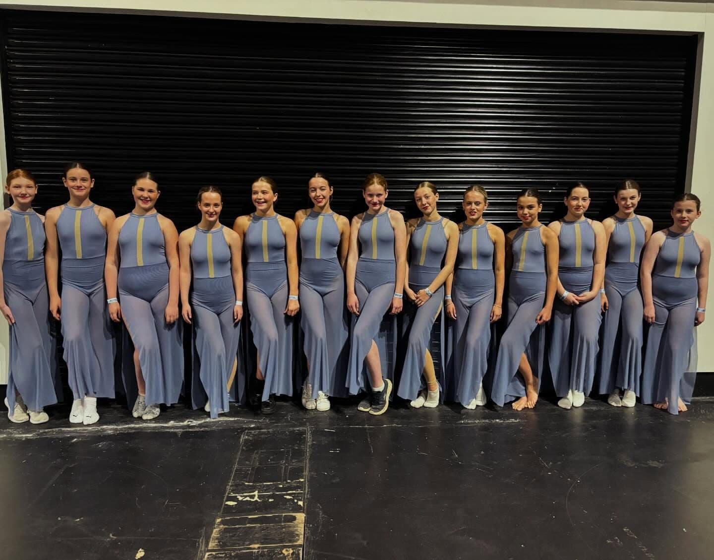 A line-up of Amelia K Academy students of different ages in the studio