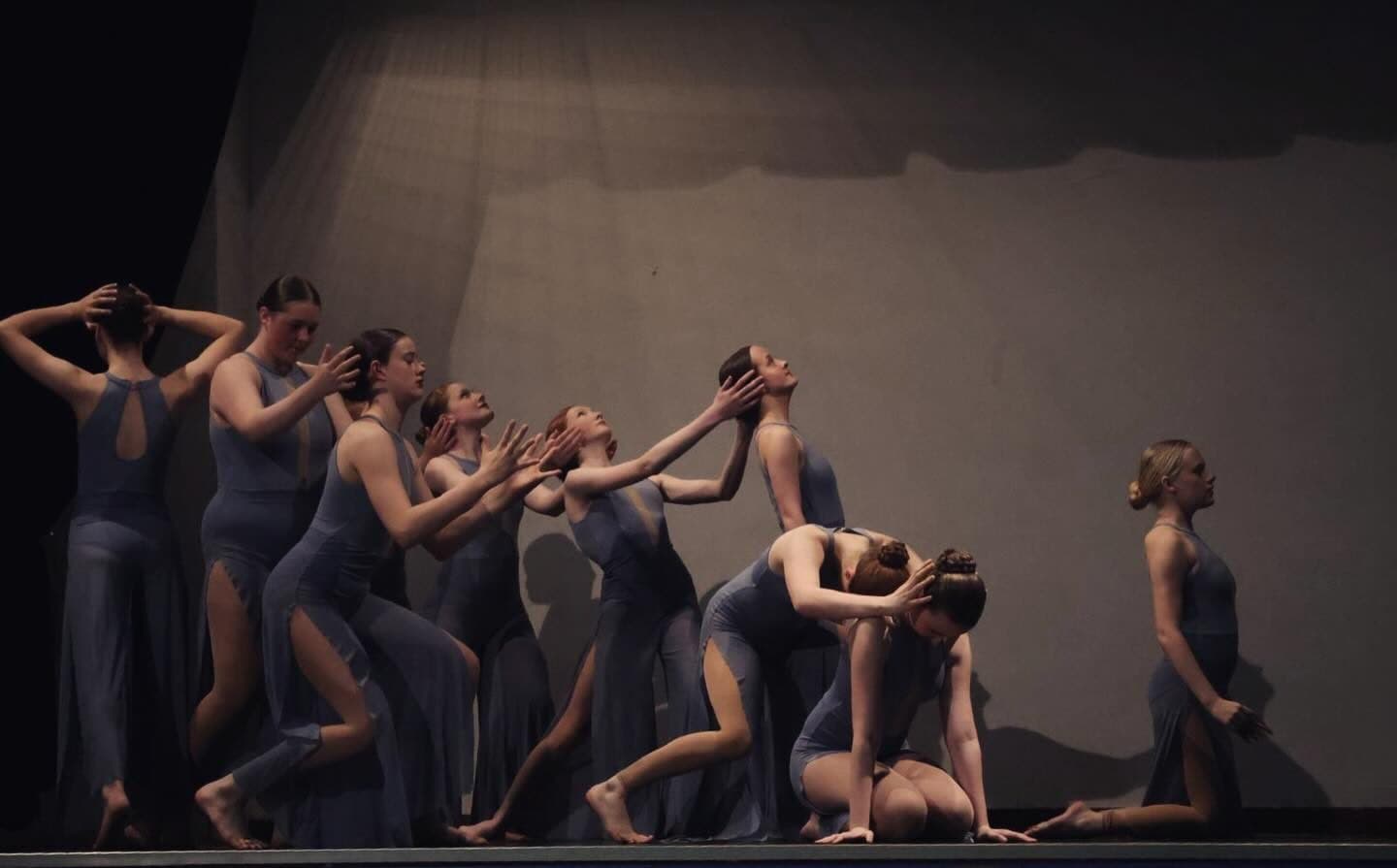 Ensemble in a dramatic line under blue light