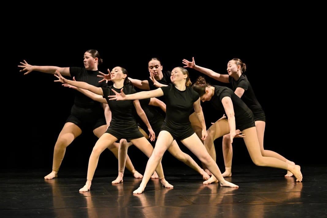 Senior contemporary ensemble holding a sharp formation on stage