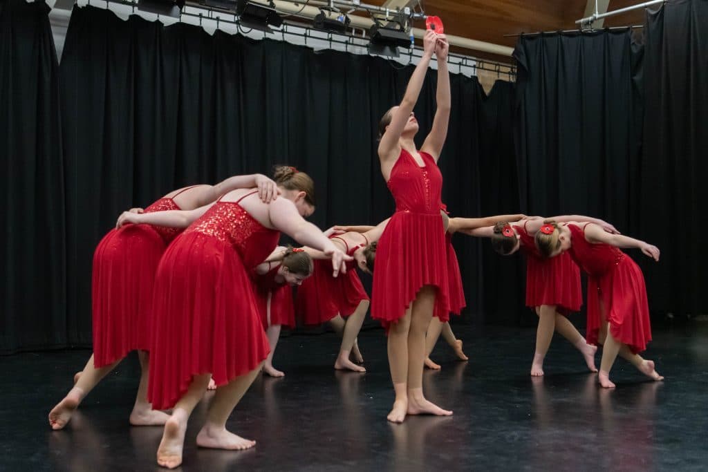 Duet performing in red on stage